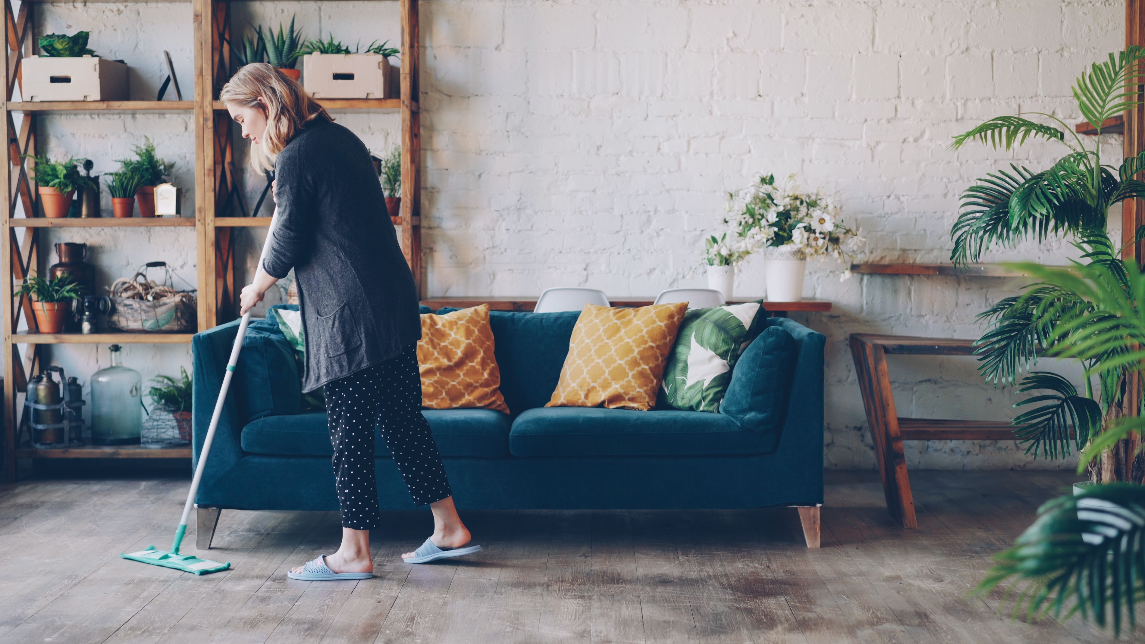 A bright living room being cleaned with a mop